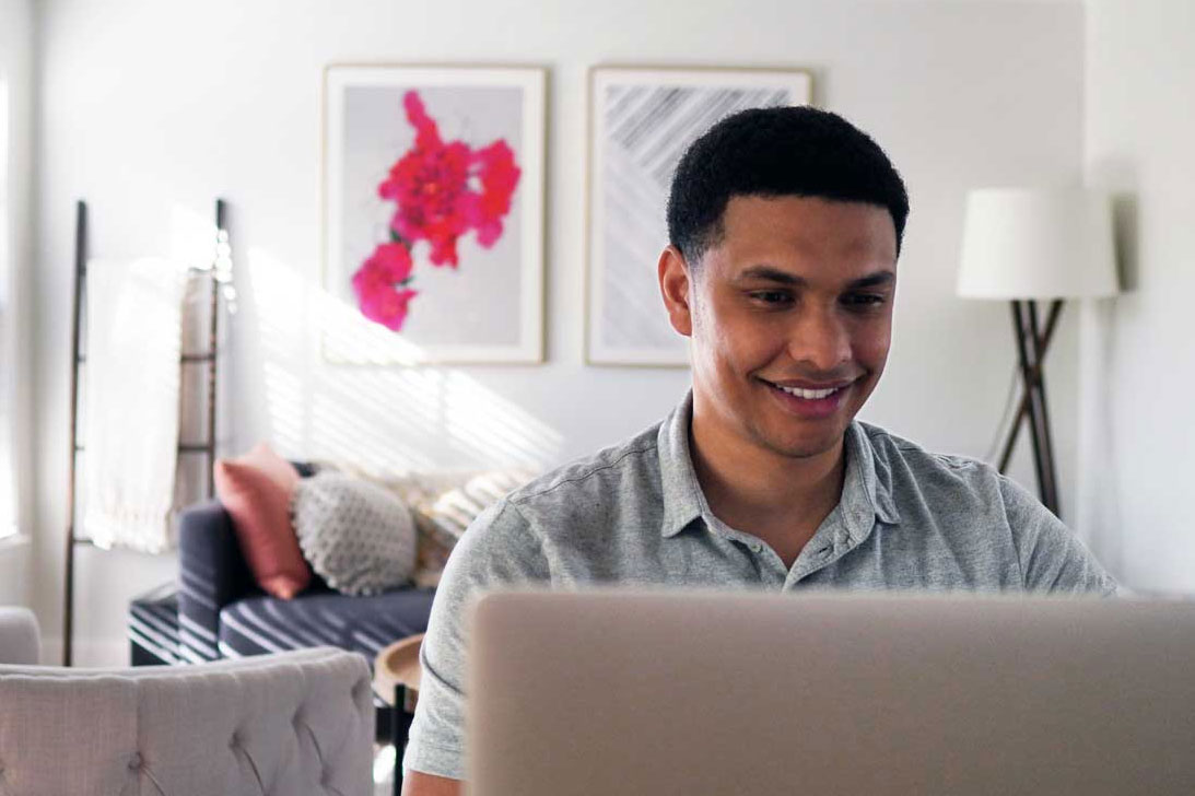 *A man on the computer searching how to choose a personal loan in Alabama