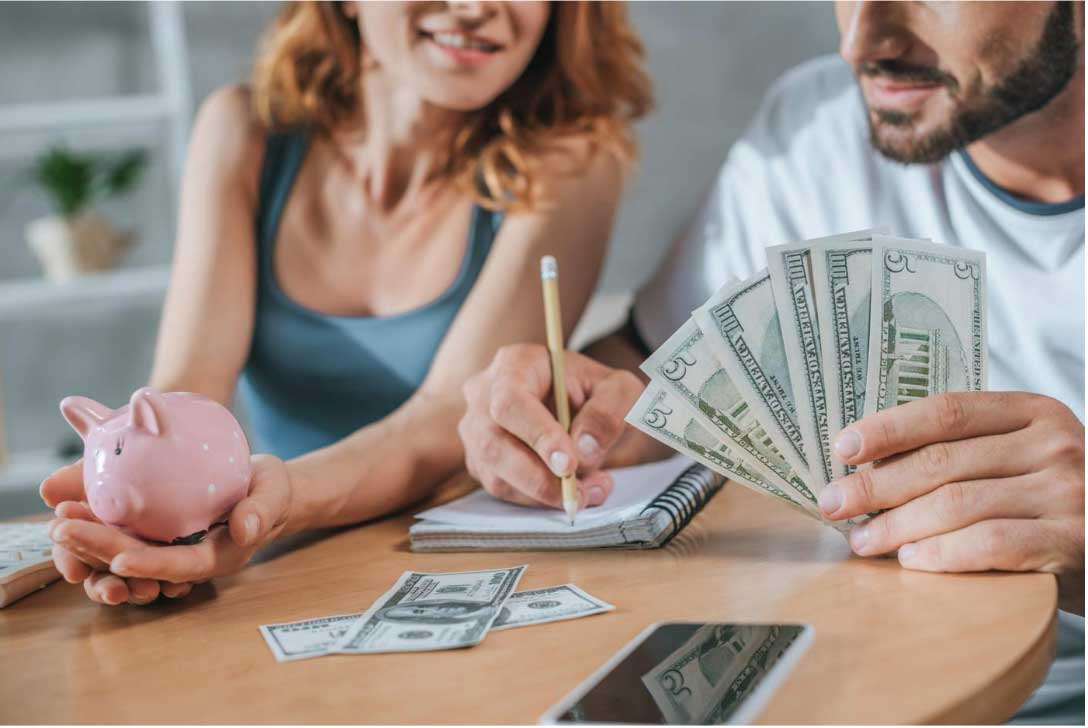 A couple sitting at a table planning their financial wellness goals